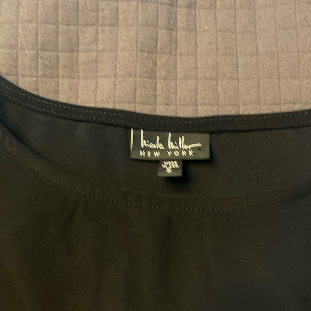 black Nicole Miller top with long sleeve flared, with cold shoulder.